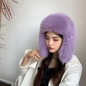 Close-up of a stylish purple faux fox fur Ushanka hat worn by a model for winter warmth