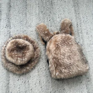 Detail shot of fluffy faux raccoon fur backpack and matching hat set for Y2K fashion style.