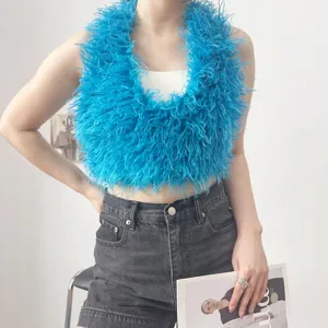 Top halter blu in finta pelliccia di pecora mongola abbinato a pantaloncini di jeans