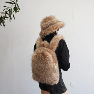 Woman wearing matching faux raccoon fur bucket hat and fuzzy Y2K style backpack