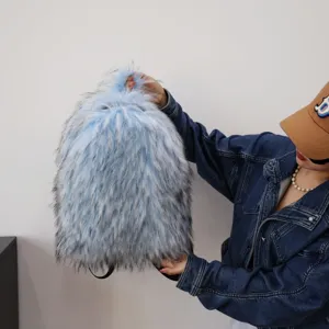 Detailed close-up of light blue fluffy faux raccoon fur backpack with soft, voluminous texture