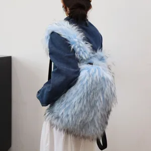 Detail of light blue fluffy faux raccoon fur backpack with Y2K fashion style on back.