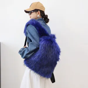 Detailed view of a Y2K blue faux raccoon fur backpack worn by a model in denim.