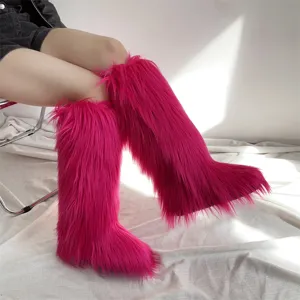 Detail of vibrant fuchsia long faux fur knee-high snow boots for women