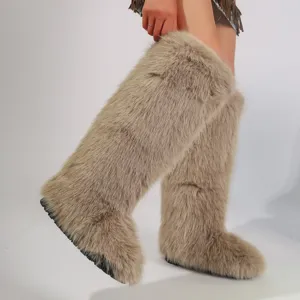 Close-up detail of knee-high light brown faux fox fur snow boots in trendy Y2K style