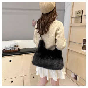 Back view of model carrying a black faux fur plush bag in a stylish boutique setting
