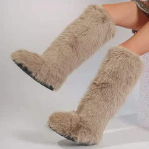 Detail shot showing the soft texture of beige knee-high faux fur boots in Y2K style