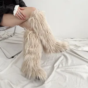 Detailed close-up showing the soft texture of beige faux fur knee-high snow boots for women