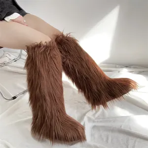 Detailed view of fluffy brown faux fur knee-high boots with long shaggy texture.