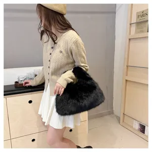 Model showcasing a fluffy black faux fur tote bag in a stylish indoor setting.