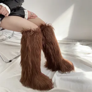 Macro view of brown faux fur knee-high boots with a luxurious long hair texture