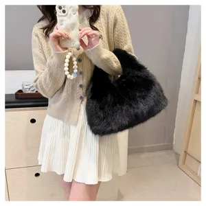 Stylish model carrying a fluffy black faux fur handbag paired with a beige knit cardigan.