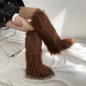 Macro detail of brown faux fur knee-high snow boots featuring fluffy long plush texture.