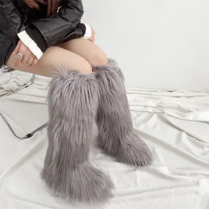 Close-up of grey faux fur knee-high snow boots for winter fashion style