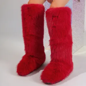 Detailed macro shot showing the lush texture of red faux fur knee-high Y2K snow boots