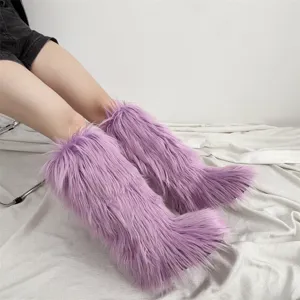 Detailed view of purple faux fur knee-high boots featuring long plush texture on model