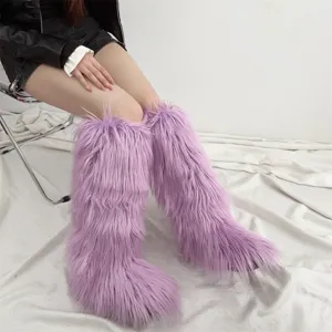 Detailed view of trendy purple faux fur knee-high boots with long shaggy texture