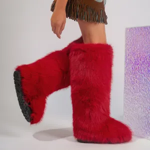 Stylish vibrant red faux fur knee-high boots in Y2K style shown on a model's feet