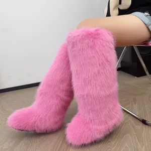 Detailed macro view showing the texture of pink faux fur knee high boots in Y2K style.
