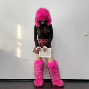 Fashion detail of bright pink Y2K faux fur knee-high boots and matching trapper hat outfit