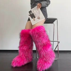 Close-up of Y2K style hot pink faux fur knee-high snow boots for cozy winter warmth.