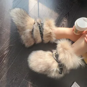 Chic Y2K punk style faux fur snow boots with rivet buckle straps shown on dark wood floor