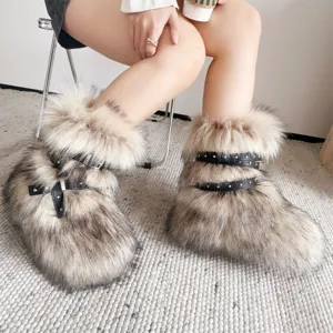 Detailed macro view of Y2K punk style faux fur snow boots featuring black rivet straps