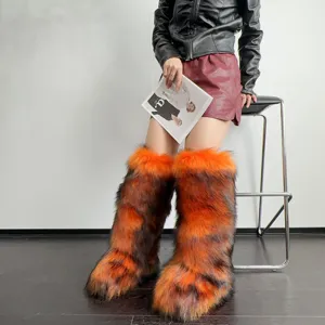 Faux fur knee-high snow boots in vibrant orange and brown tiger stripe pattern