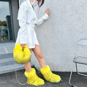 Bold Y2K style fluffy faux raccoon fur snow boots and matching chain handbag set