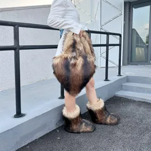 Model wearing faux raccoon fur snow boots and matching heart-shaped handbag in Y2K style