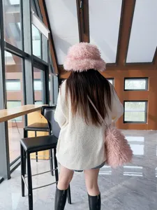 Set cappello a secchiello e borsa tote in finta lana rosa indossato da modella al caffè