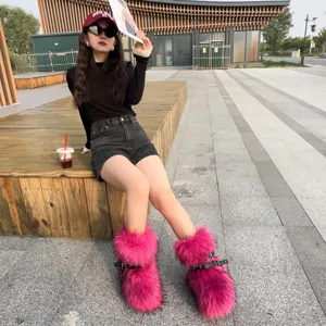 Asian model wearing hot pink faux fur Y2K punk snow boots with black buckle straps.