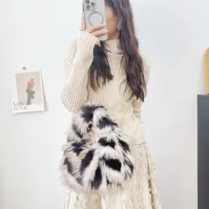 Detalle de bolso de piel de zorro sintética con manchas jacquard en el conjunto