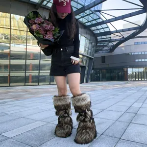 Stylish Y2K faux fur boots with buckle straps shown in a chic outdoor street setting
