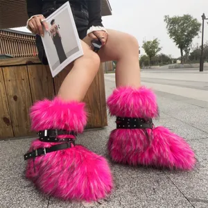 Close-up of bright pink faux fur Y2K punk platform boots with black rivet straps