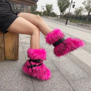 Detail of pink faux fur Y2K punk boots with black buckled straps and metal rivets.