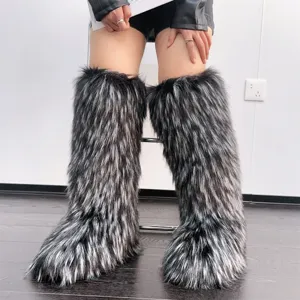 Macro view of knee-high faux fur boots with black and silver Y2K style textures.