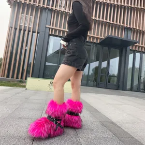 Hot pink Y2K style faux fur boots with black buckle straps and stud detailing
