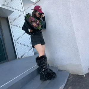 Faux fur high-top platform boots with punk rivet straps as seen on a model outdoors.