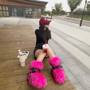 Vibrant hot pink faux fur platform snow boots with rivet straps in a Y2K punk style
