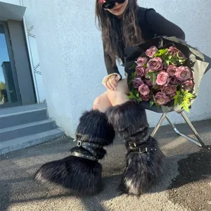 Black faux fur Y2K punk style snow boots with rivet straps and thick soles on model
