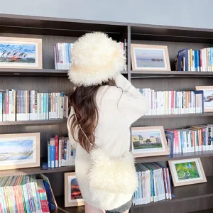 Back view of a woman wearing a plush gradient faux lamb wool hat and matching crossbody bag