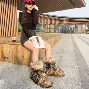 Close-up of Y2K punk style faux fur snow boots with decorative studs and straps
