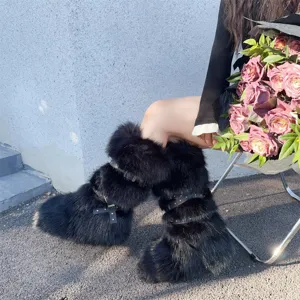 Stylish black faux fur snow boots with punk studs and buckles shown in a street style detail view.