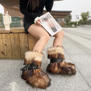 Stylish Y2K punk faux fur snow boots with rivet buckles worn by a model outdoors.