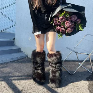 Detailed view of Y2K punk style black faux fur snow boots with stylish buckle straps.