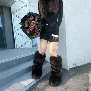 Detailed view of Y2K punk style black faux fur platform boots with silver rivet straps.