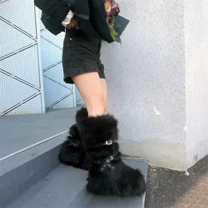 Detail view of black faux fur Y2K punk snow boots featuring buckle straps and studs