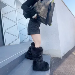 Detailed view of black Y2K punk style faux fur platform snow boots with rivet buckles