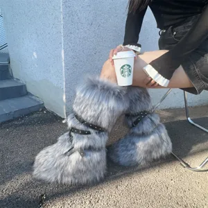 Detail view of Y2K grey faux fur boots with black studded straps and platform sole